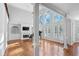 Open living room with a fireplace, built-in shelves, a piano, and large windows at 4030 Greatwood Path, Alpharetta, GA 30005