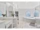The main bathroom offers marble floors, soaking tub, a glass enclosed shower, and custom mirrors at 4030 Greatwood Path, Alpharetta, GA 30005