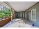 Covered patio area with tiled flooring, offering a relaxing outdoor space at 4030 Greatwood Path, Alpharetta, GA 30005