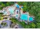 This aerial view captures a full aquatics center featuring pools, a waterslide, and ample lounging space at 4030 Greatwood Path, Alpharetta, GA 30005