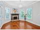 Cozy sitting room with a stone fireplace, large windows, and hardwood flooring at 4030 Greatwood Path, Alpharetta, GA 30005