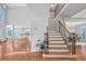 Grand staircase with wood railing, hardwood floors, and views into the living area at 4030 Greatwood Path, Alpharetta, GA 30005