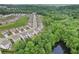 High angle view showcasing a community nestled among lush greenery and a tranquil pond at 4189 Brookmont Way, Auburn, GA 30011