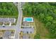 Aerial view of neighborhood pool and parking area surrounded by dense trees at 4189 Brookmont Way, Auburn, GA 30011