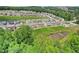 An aerial view of a residential community with a mix of homes and a nearby pool at 4189 Brookmont Way, Auburn, GA 30011