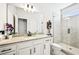 Modern bathroom with a glass-enclosed shower, granite countertop vanity, and neutral tiling for a spa-like ambiance at 4189 Brookmont Way, Auburn, GA 30011