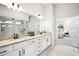 Modern bathroom with double sinks, granite counters, large mirror, and glass-enclosed shower at 4189 Brookmont Way, Auburn, GA 30011