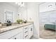 Elegant bathroom with double granite-top sinks, modern fixtures, and a view into the bedroom at 4189 Brookmont Way, Auburn, GA 30011