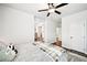 Well-lit bedroom with neutral tones and glimpses of a living area and hallway at 4189 Brookmont Way, Auburn, GA 30011
