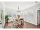 Bright breakfast nook with hardwood floors, multiple windows, and a cozy dining setup at 4189 Brookmont Way, Auburn, GA 30011