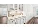 Butler's pantry with white cabinetry, countertops, and decorative tile backsplash at 4189 Brookmont Way, Auburn, GA 30011