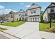 Stunning two-story home with a long driveway, white siding, and black trim at 4189 Brookmont Way, Auburn, GA 30011