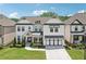 Stunning two-story home with a welcoming front porch, beautiful landscaping, and a three-car garage at 4189 Brookmont Way, Auburn, GA 30011
