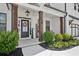 Inviting front porch with dark wood columns, colorful flowers and a 'Welcome' sign at 4189 Brookmont Way, Auburn, GA 30011