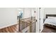 Upstairs hallway with wrought iron banister and hardwood floors, connecting to bedrooms and other living areas at 4189 Brookmont Way, Auburn, GA 30011