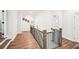 Spacious hallway with hardwood floors and a wrought iron banister, creating an elegant transition between living spaces at 4189 Brookmont Way, Auburn, GA 30011
