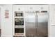 Kitchen with stainless appliances including built-in oven, microwave, and refrigerator at 4189 Brookmont Way, Auburn, GA 30011