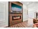 Bright living room with hardwood floors, a fireplace, and seamless connection to the pantry at 4189 Brookmont Way, Auburn, GA 30011