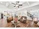 Open-concept living room with coffered ceilings, hardwood floors, and seamless flow to the kitchen at 4189 Brookmont Way, Auburn, GA 30011