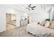 Bright bedroom with tray ceiling, carpeted floors, and ensuite bath at 4189 Brookmont Way, Auburn, GA 30011