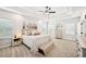Spacious bedroom featuring a tray ceiling, neutral decor, carpeted floors and lots of natural light at 4189 Brookmont Way, Auburn, GA 30011