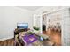 Stylish home office featuring a modern desk with decorative accents, bright lighting, and hardwood floors at 4189 Brookmont Way, Auburn, GA 30011