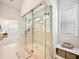Sleek glass-enclosed shower with tiled walls and floors in a luxurious bathroom at 4189 Brookmont Way, Auburn, GA 30011