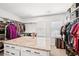 Large walk-in closet with custom shelves, drawers, and granite topped island at 4189 Brookmont Way, Auburn, GA 30011