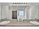 Bathroom featuring a double sink vanity, a large mirror, and decor pieces around the sink at 4240 N Braves Cir, Douglasville, GA 30135
