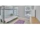 Well-lit bedroom showcasing a bunk bed, windows with blinds and purple rug at 4240 N Braves Cir, Douglasville, GA 30135
