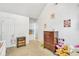 Bright bedroom featuring a closet, dresser, and toys with neutral-colored walls at 4240 N Braves Cir, Douglasville, GA 30135