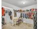 Walk-in closet including clothing racks, a center desk, and shelves for handbags and accessories at 4240 N Braves Cir, Douglasville, GA 30135