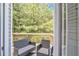 View through open door of deck with outdoor seating, providing a cozy and relaxing outdoor space at 4240 N Braves Cir, Douglasville, GA 30135