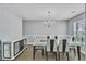 Modern dining room featuring an elegant chandelier, stylish furniture, and hardwood floors at 4240 N Braves Cir, Douglasville, GA 30135