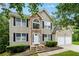 Charming two-story home with stone accents, a two-car garage, and manicured front yard at 4240 N Braves Cir, Douglasville, GA 30135