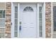 Close-up of a white front door with sidelights and decorative stone trim at 4240 N Braves Cir, Douglasville, GA 30135