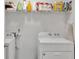 Bright laundry room features a washer, dryer, and shelf storage with cleaning supplies at 4240 N Braves Cir, Douglasville, GA 30135