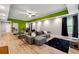 Spacious recreational room with a large sofa and wall mounted screen for entertainment and leisure at 4240 N Braves Cir, Douglasville, GA 30135