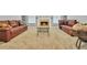 Inviting living room with a cozy fireplace and comfortable leather sofas at 4240 N Braves Cir, Douglasville, GA 30135