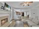 Open-concept living room with a fireplace, TV, and hardwood floors at 4240 N Braves Cir, Douglasville, GA 30135