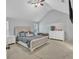 Spacious main bedroom with a large bed, dresser, and neutral decor at 4240 N Braves Cir, Douglasville, GA 30135