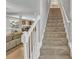 Carpeted stairway leading to the next level with a white railing at 4240 N Braves Cir, Douglasville, GA 30135