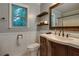 Charming bathroom featuring a wood vanity, decorative mirror, and white wainscoting at 224 Amy Blvd, Temple, GA 30179