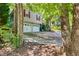 Wide driveway leading to a two-car garage, framed by lush trees and landscaping at 224 Amy Blvd, Temple, GA 30179