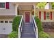 Inviting front porch with steps, decorative columns, and a stylish red front door at 224 Amy Blvd, Temple, GA 30179