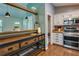 Charming kitchen showcasing wood flooring, stainless appliances, and a view into the living area at 224 Amy Blvd, Temple, GA 30179