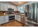Cozy kitchen featuring stainless steel appliances, white cabinets, and wood countertops at 224 Amy Blvd, Temple, GA 30179