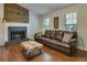 Cozy living room with a fireplace, hardwood floors, and a comfortable leather sofa at 224 Amy Blvd, Temple, GA 30179