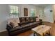Comfortable living room featuring a plush sofa, hardwood floors, and natural light at 224 Amy Blvd, Temple, GA 30179