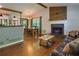Open-concept living room with hardwood floors, a stone fireplace, and a dining area at 224 Amy Blvd, Temple, GA 30179